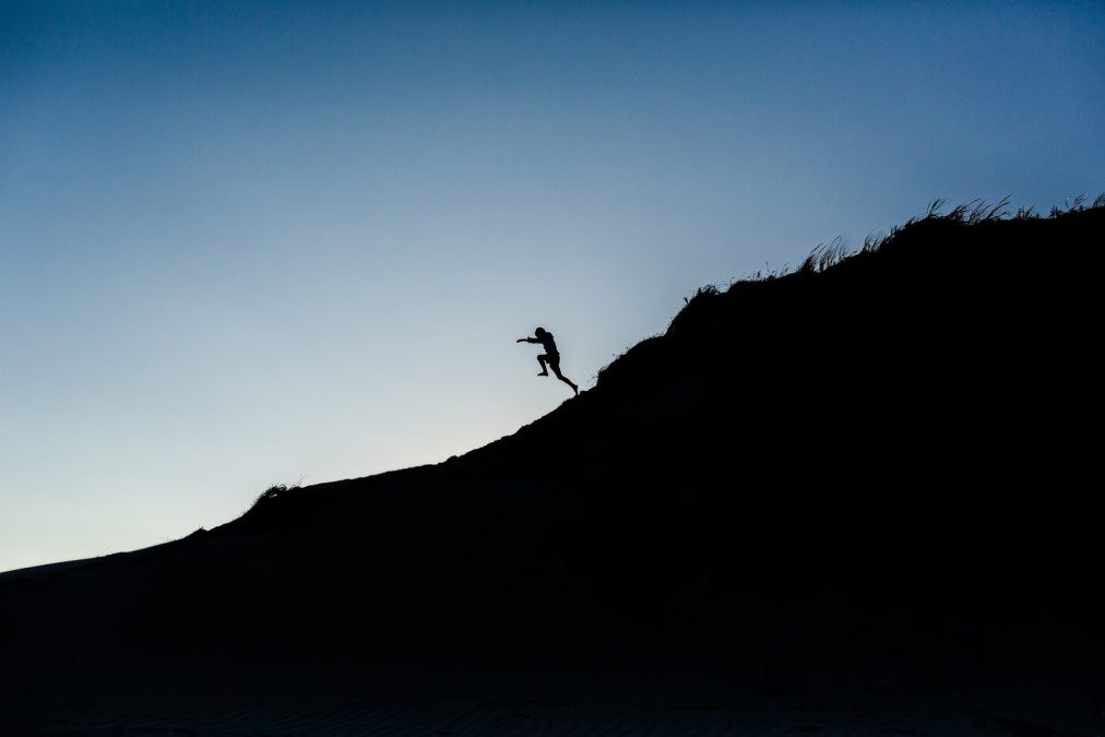 man jumping on mountain