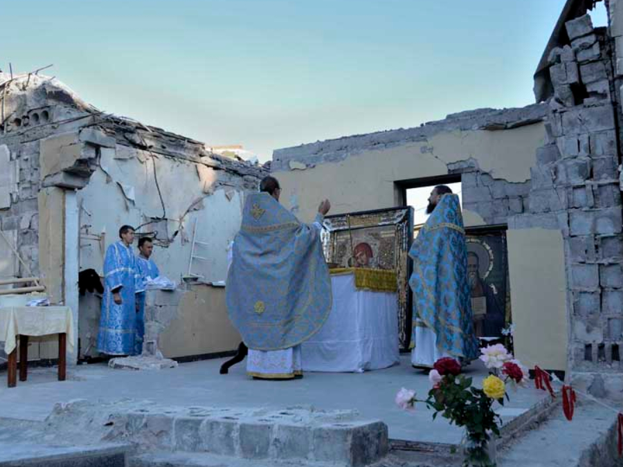 Worshippers at a bombed church in Kirovskoye, Ukraine
