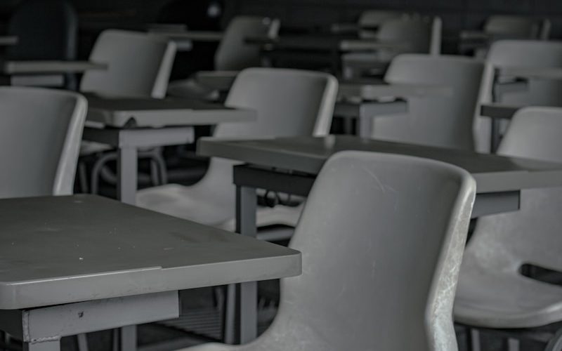 white plastic chairs in front of green table