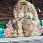 woman and girl painting on wall