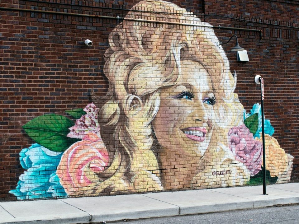 woman and girl painting on wall